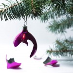 broken pink bauble hanging from a Christmas tree
