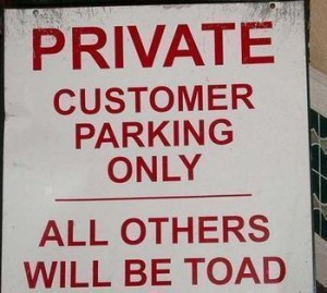 car park sign threatening non-customers will be toad