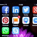 image of social media logos on a mobile phone