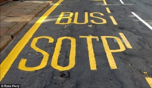 Bus stop road painting, spelled 'bus sotp'
