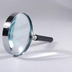 silver and glass magnifying glass