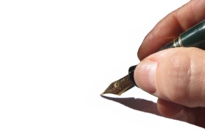 fountain pen about to start writing on a blank page